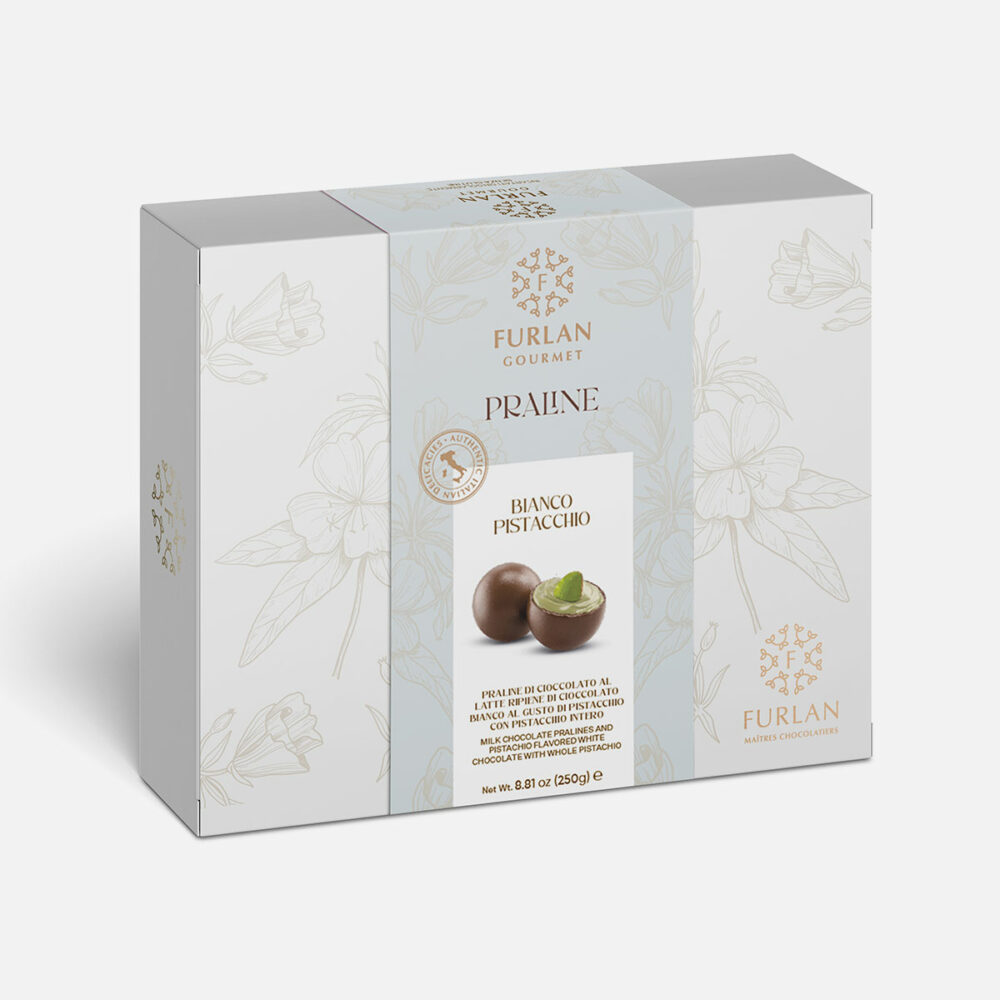Praline di cioccolato al latte ripiene di cioccolato bianco al gusto di pistacchio con pistacchio intero